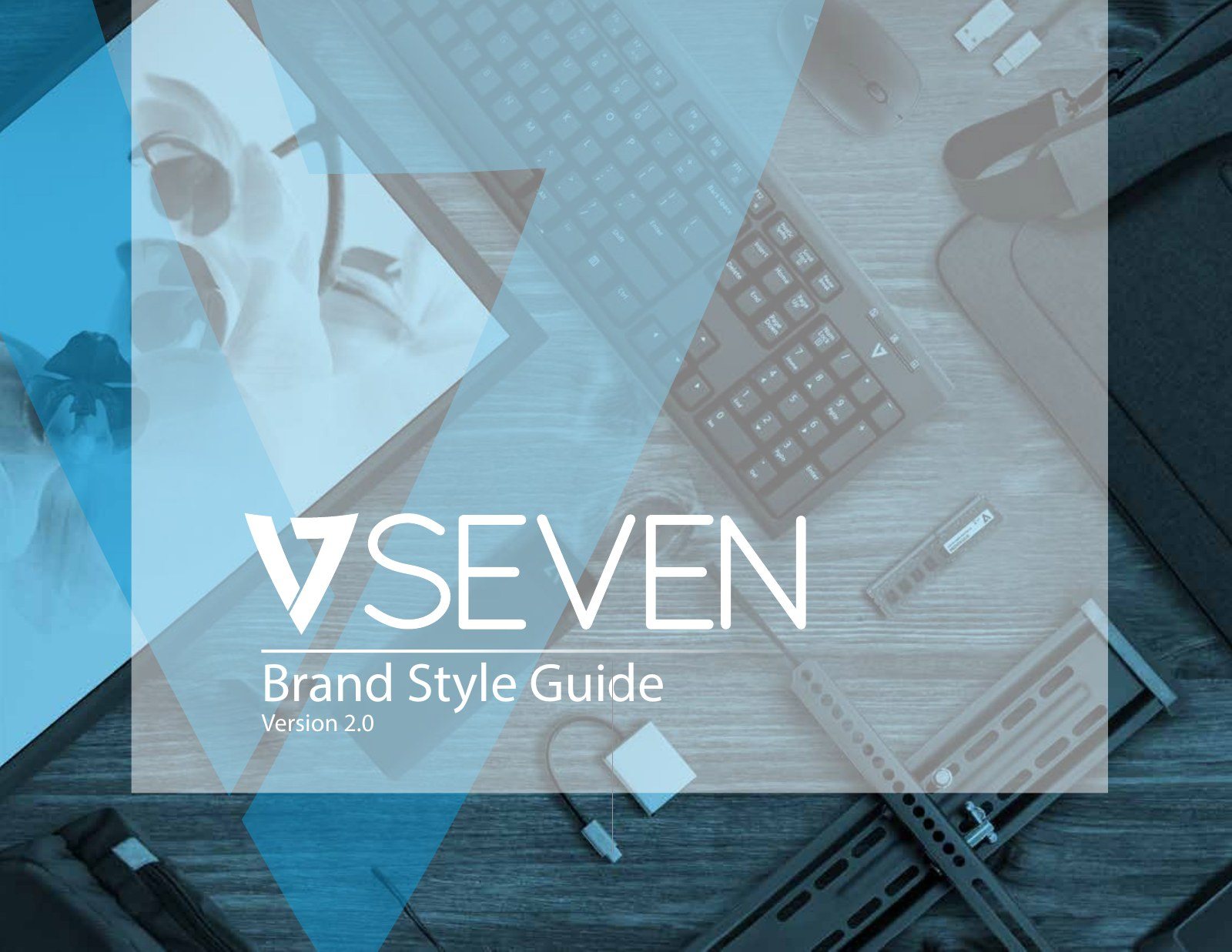 Cover of the V7 Brand Style Guide version 2.0 with the VSEVEN logo over a blue-tinted desk photo