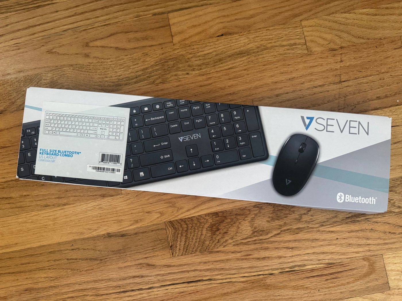 Two V7 boxes with a black keyboard and mouse visible through the front window